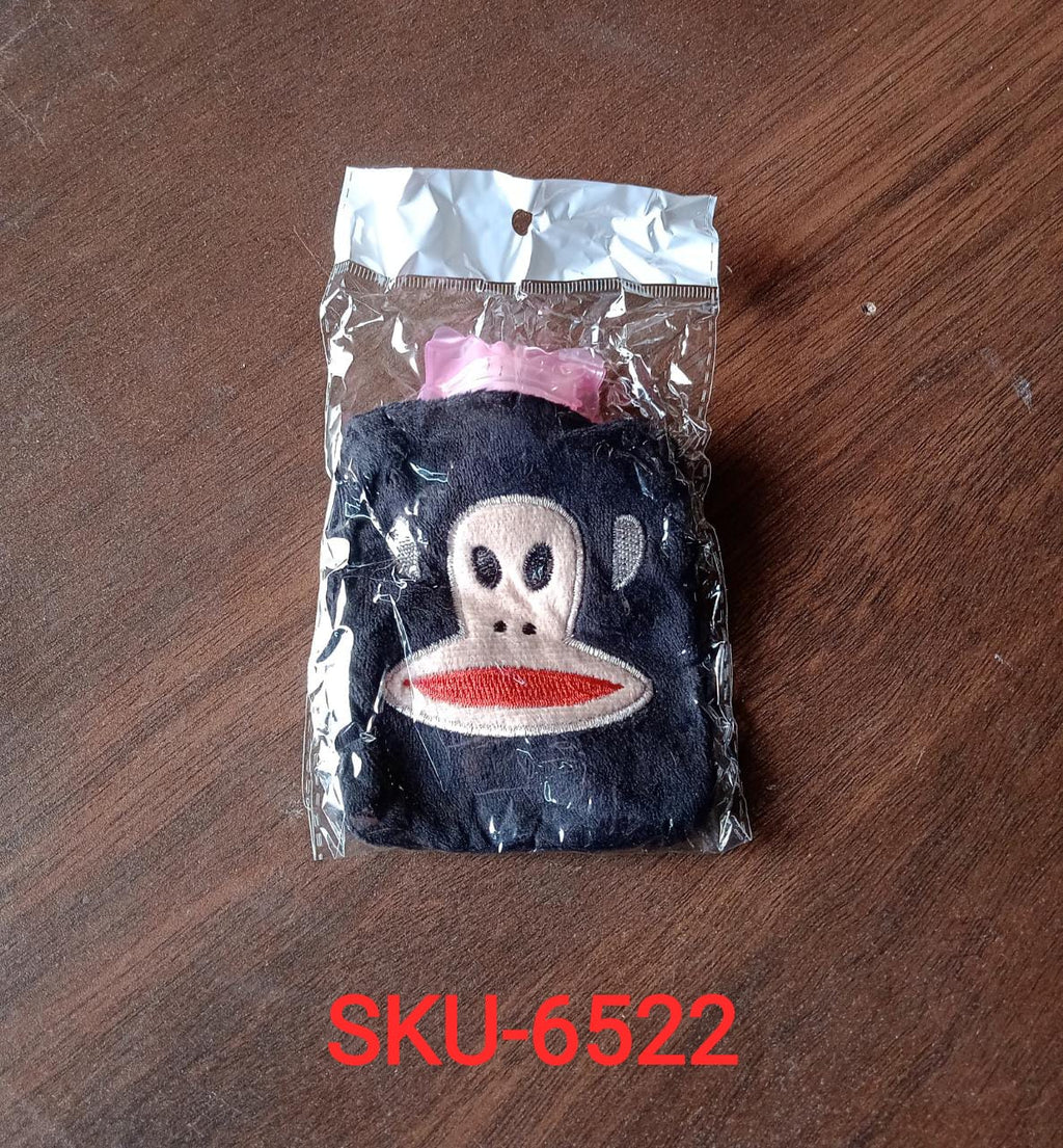 A mini hot water bag with a vibrant emoji cover in active use.