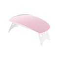 Hand curing gel nails under the portable Gel Nail Dryer.