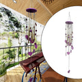 Smiley hearts wind chime with bamboo and aluminium tubes hanging outdoors.