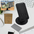 A sleek black rotating mobile stand, folded compactly on a desk, ready for use.