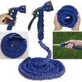 Expandable garden hose fully extended with spray gun, ready for use.