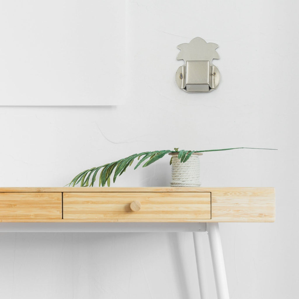 Sleek stainless steel agarbatti stand mounted on a wall.