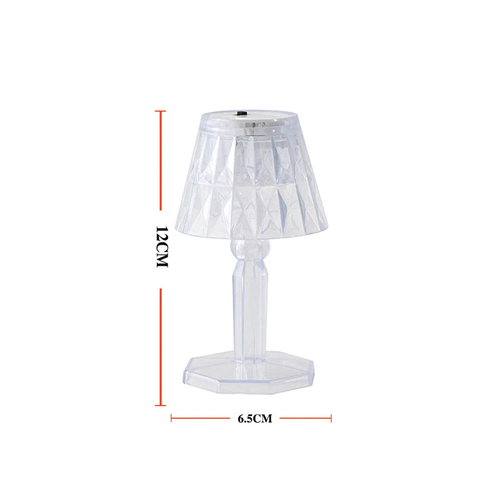 A modern mini crystal table lamp glowing softly in a contemporary interior.