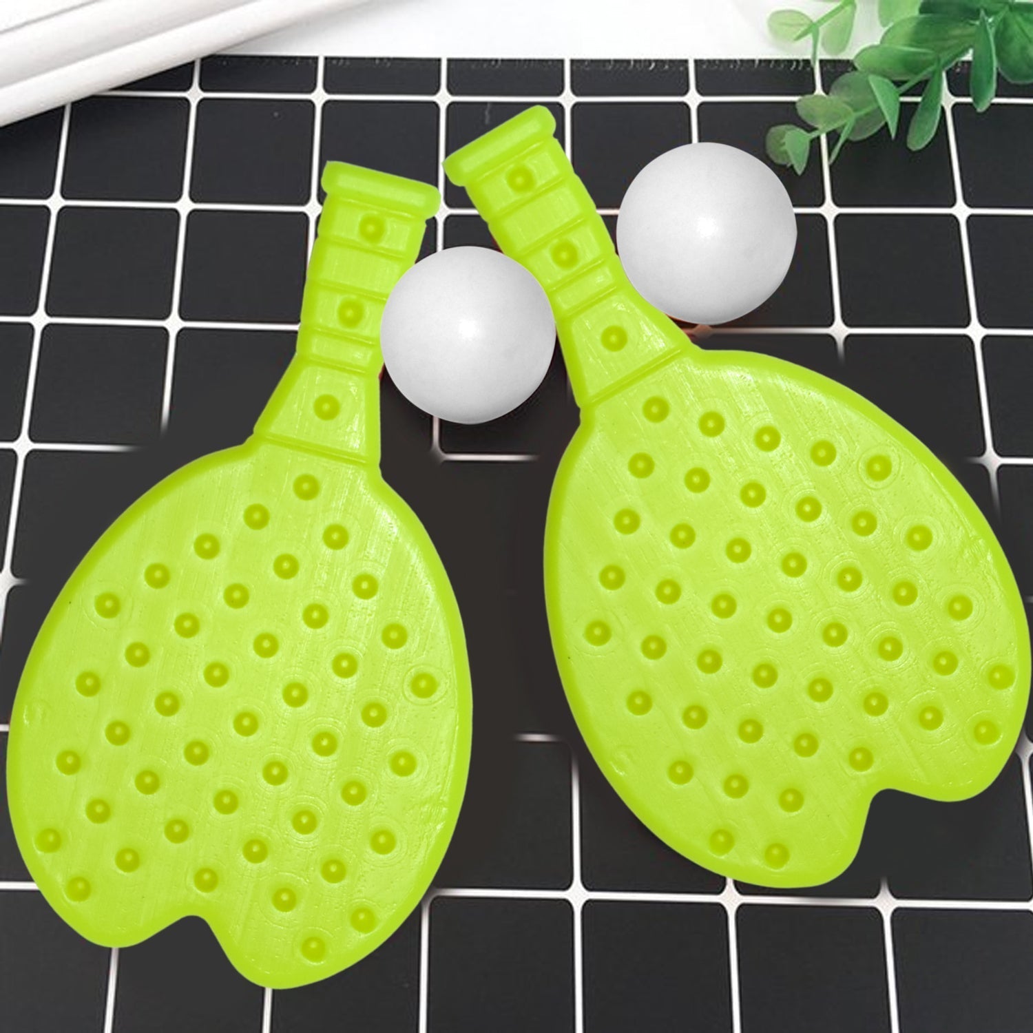 Vibrant plastic kids table tennis set with racquet and ball, perfect for indoor play.