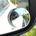 Pair of round wide-angle blind spot mirrors attached to a car's side mirror.