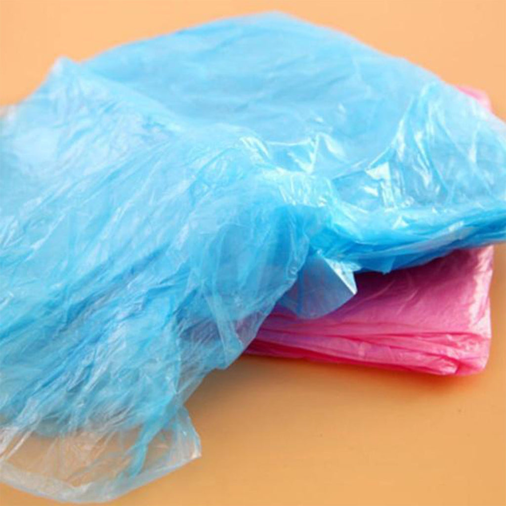 A close-up shows crumpled blue and pink translucent plastic material, likely disposable ponchos, on a flat surface.