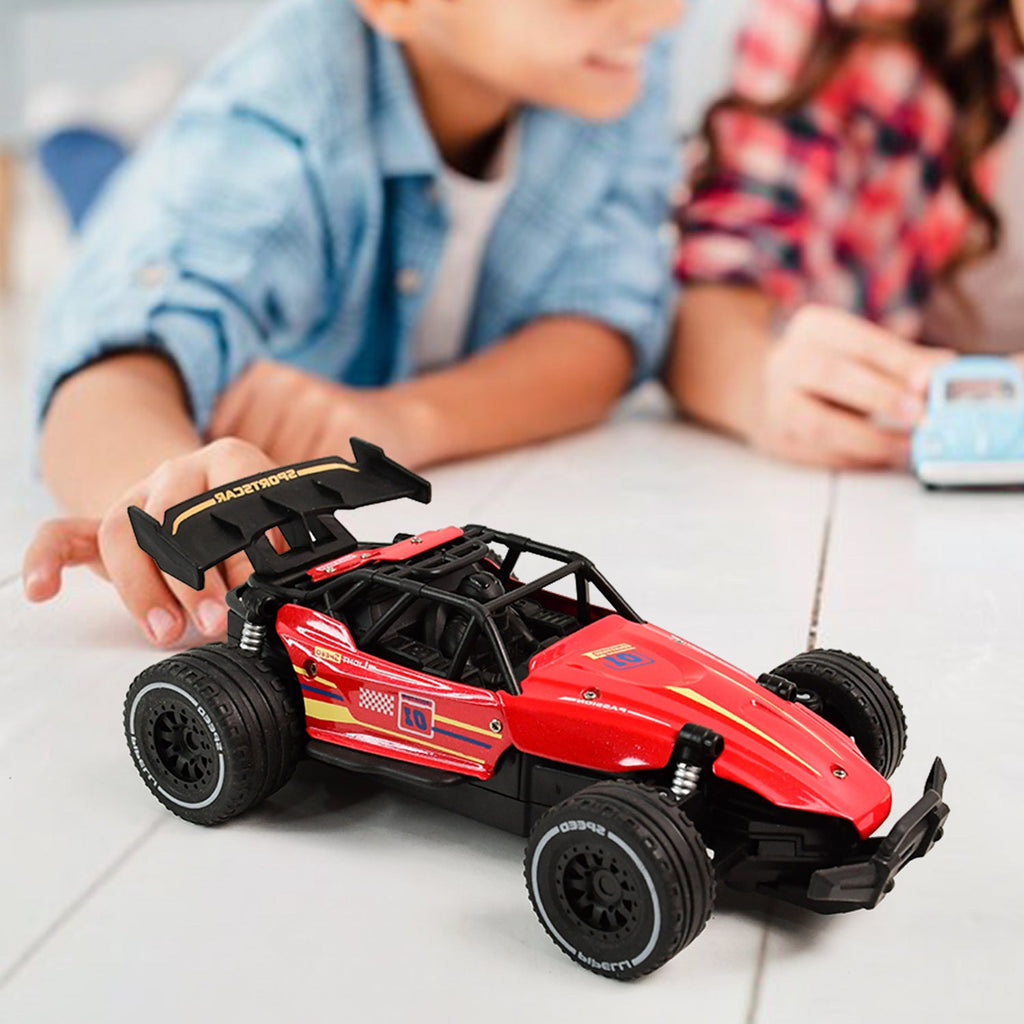 Red RC race car showing action shot on rough terrain for kids