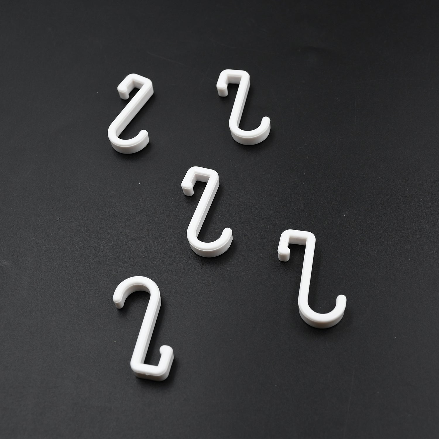 Multi-angle view of the strong self-adhesive plastic hook, highlighting its sleek design.