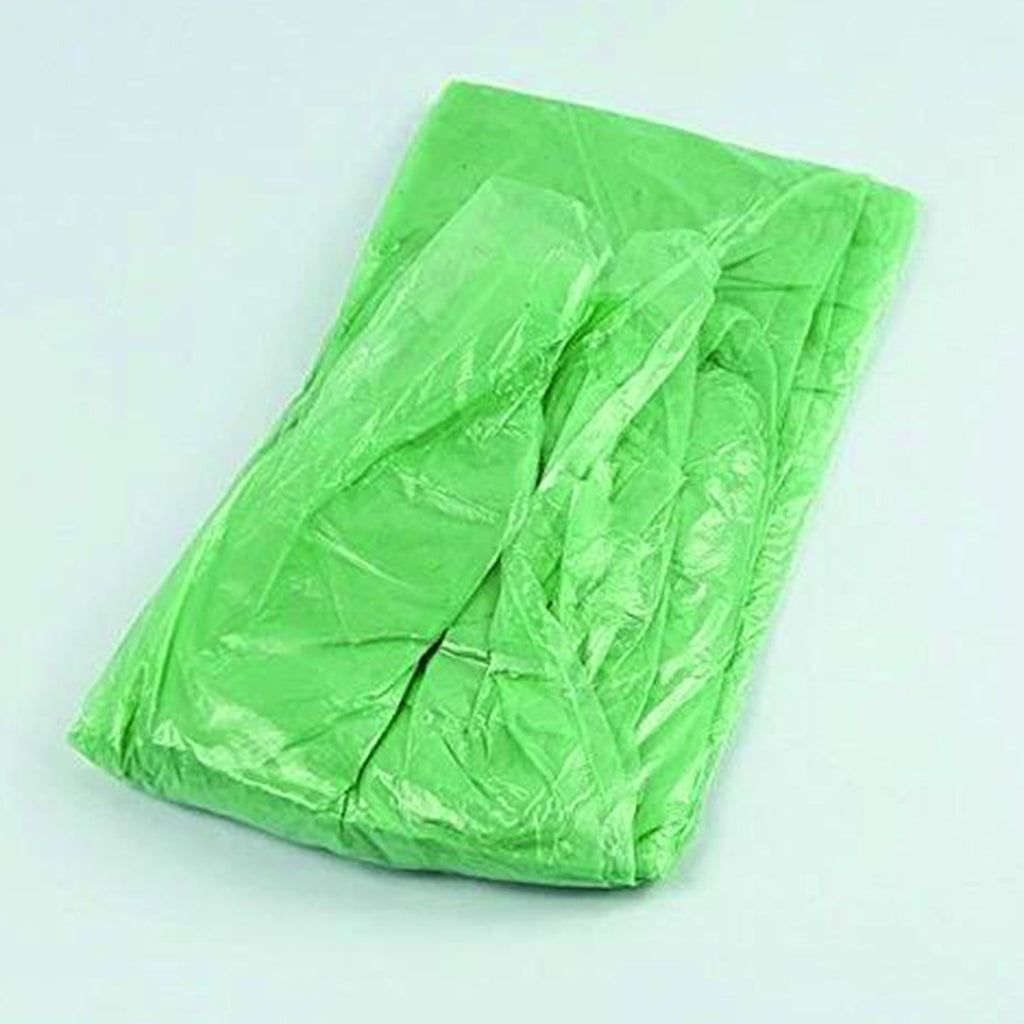 A single, rectangularly folded green plastic poncho with visible creases lies on a plain light background.
