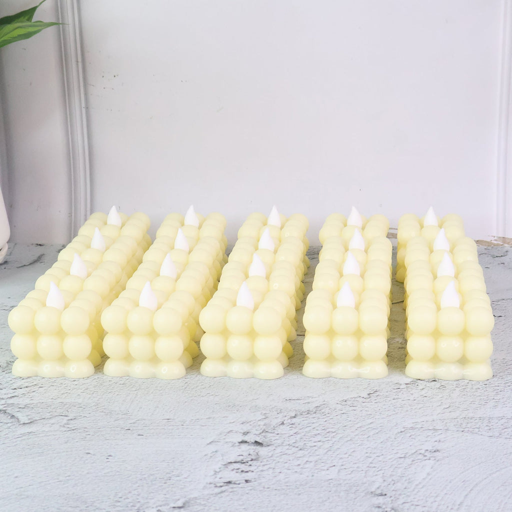 Close-up of decorative LED flameless cube candle showing bubble design and warm glow
