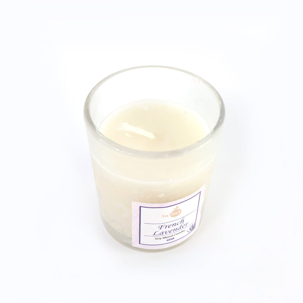 Top view of French Lavender soy candle glowing with warm flame