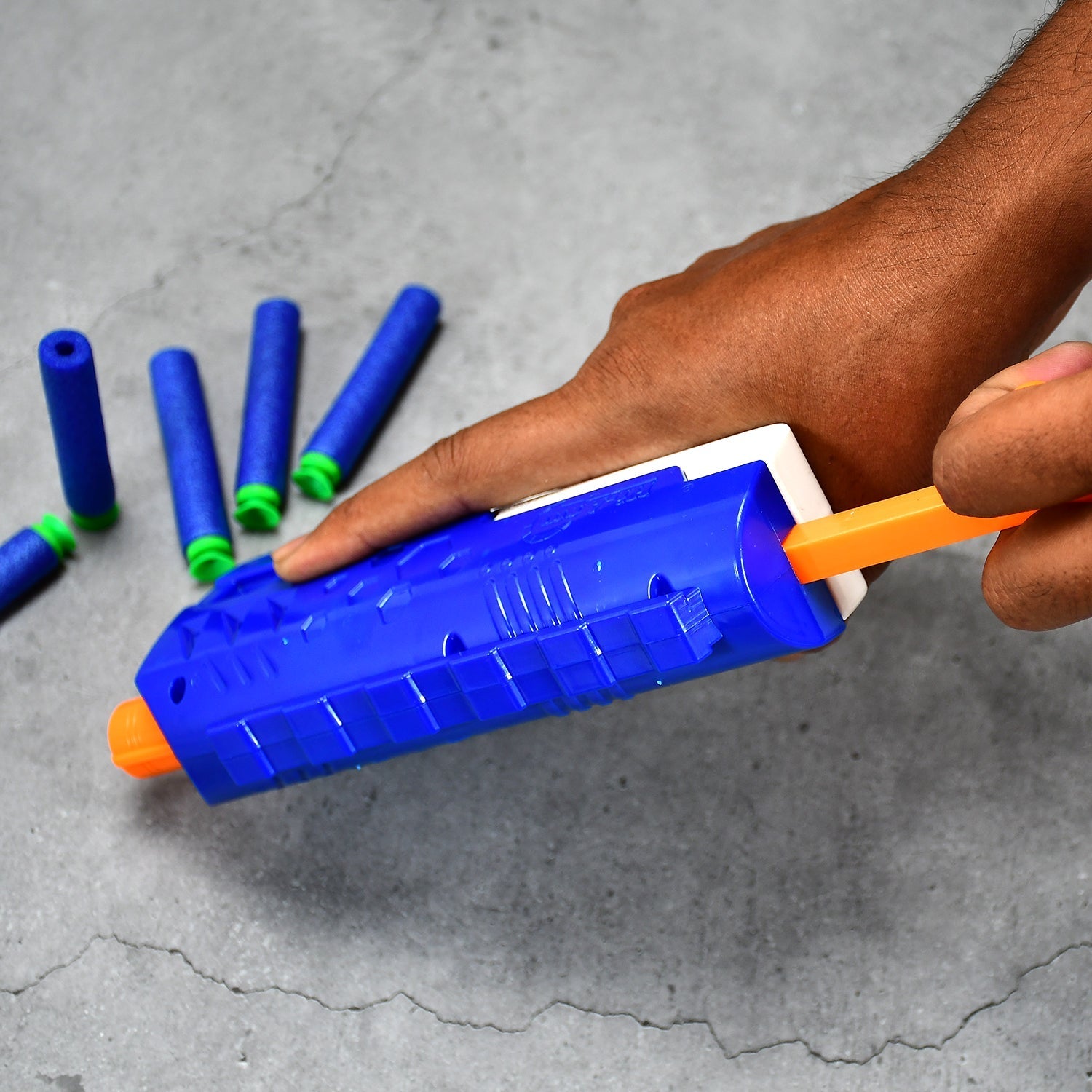 Child aiming the Aditi foam blaster gun at a target.