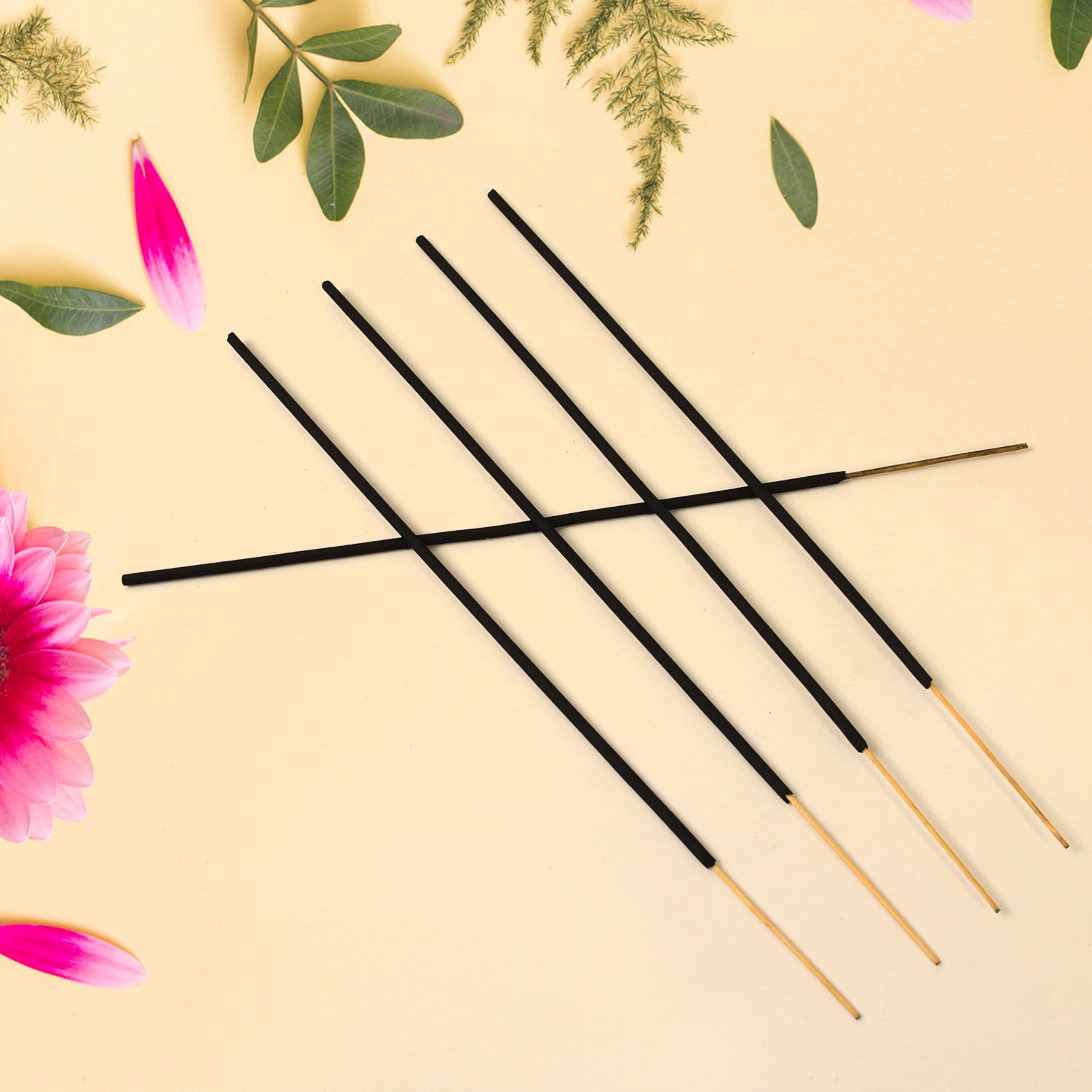 Close-up of a burning incense stick, showcasing the fine ash and glow.