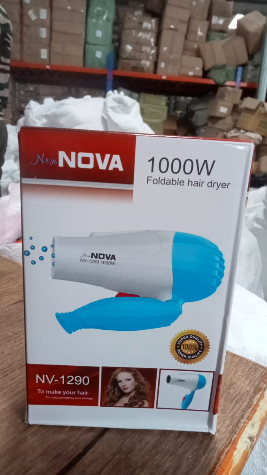 Foldable hair dryer with multiple speed options, ready for use.