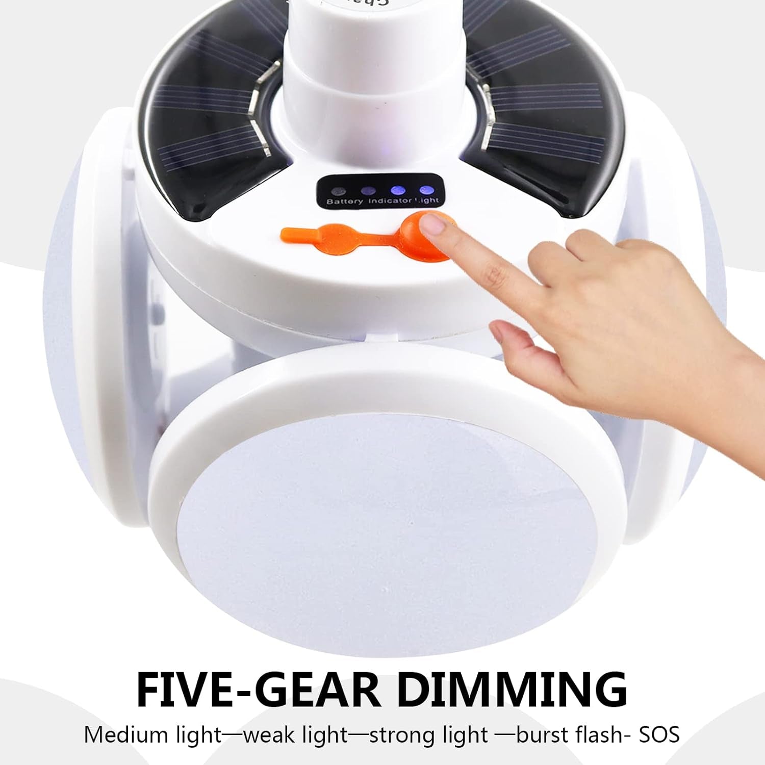 A hand presses the orange button on the white solar camping light, showing the battery indicator lights and the five-gear