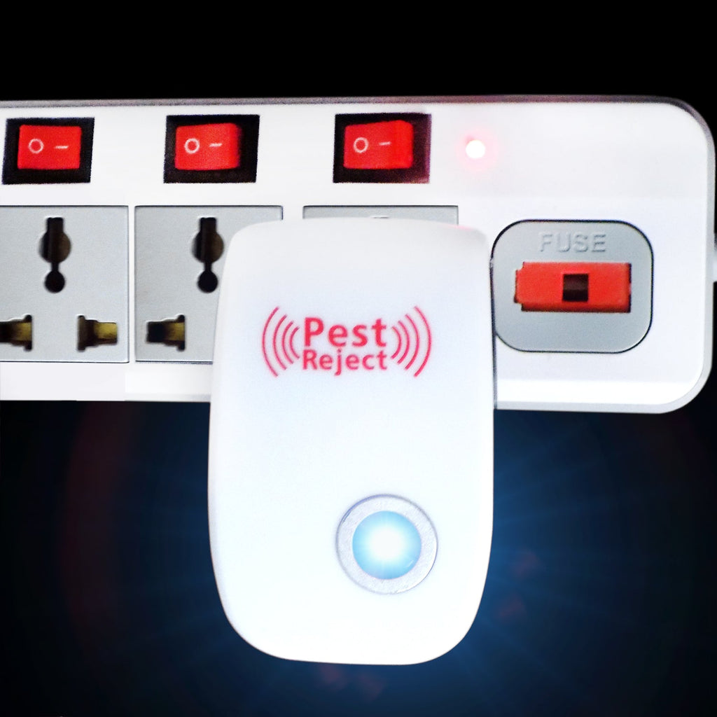 A white ultrasonic pest repeller with a blue indicator light is plugged into a white power strip with red switches.