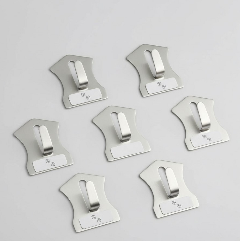 An 18-piece set of self-adhesive stainless steel wall hooks displayed on a white surface.
