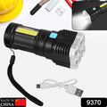 A black and silver flashlight with a wrist strap and a white USB charging cable on a white background with tools.