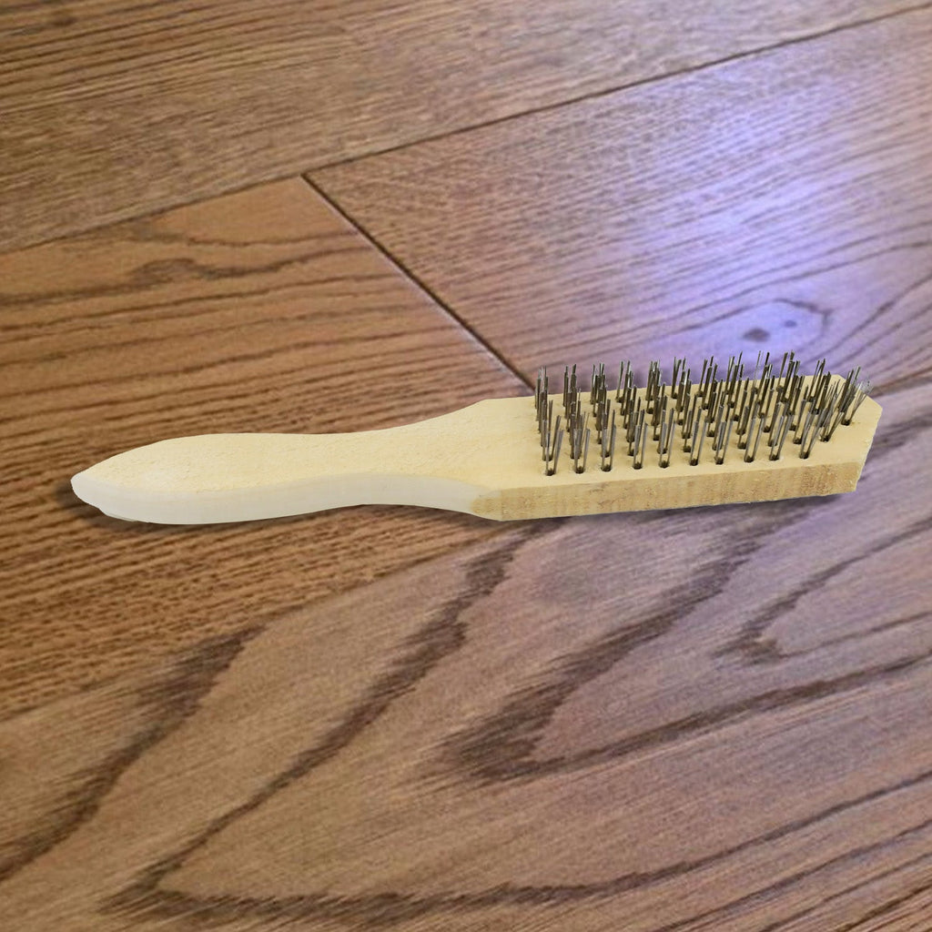 The steel wire brush on a clean white background, highlighting its design.