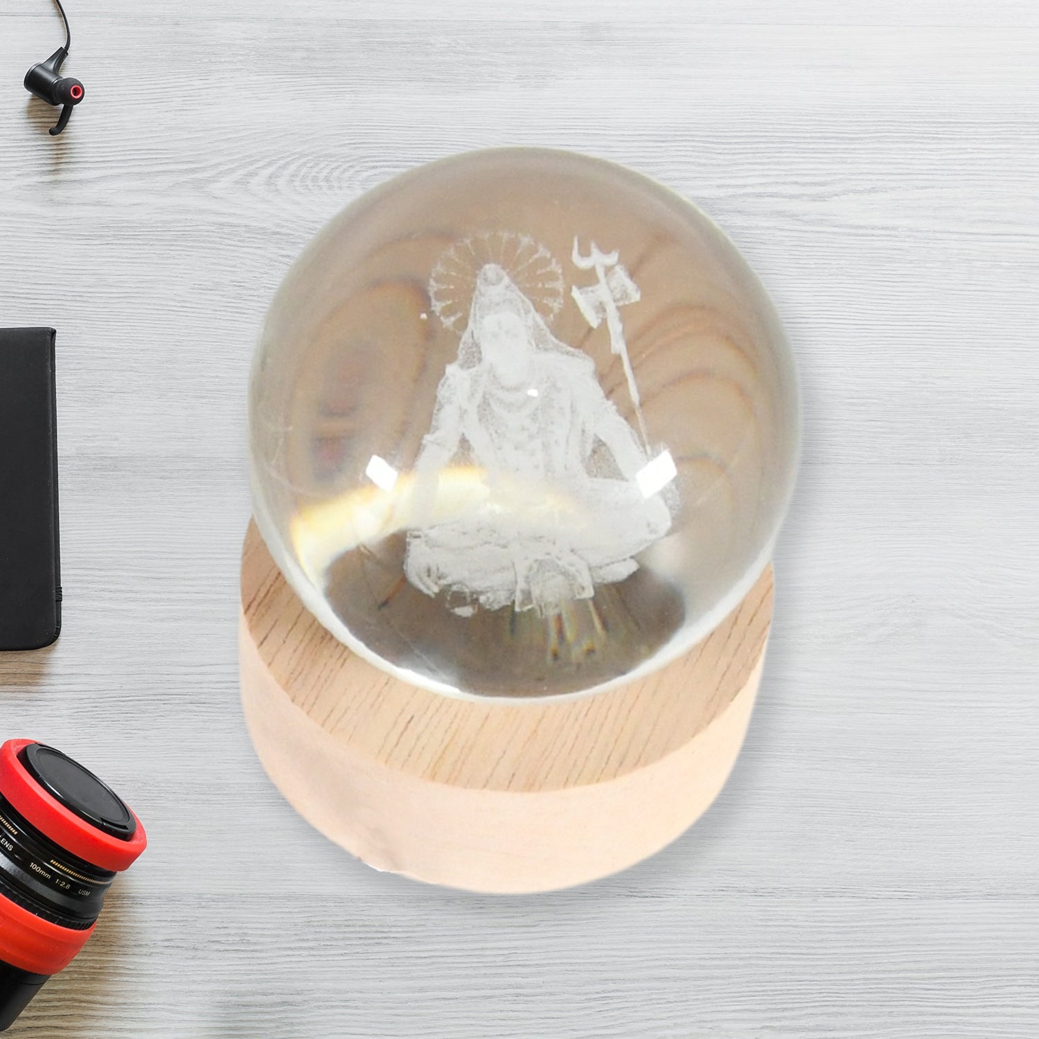 The 3D Crystal Ball Lamp creating a serene ambiance on a bedside table in a modern bedroom.