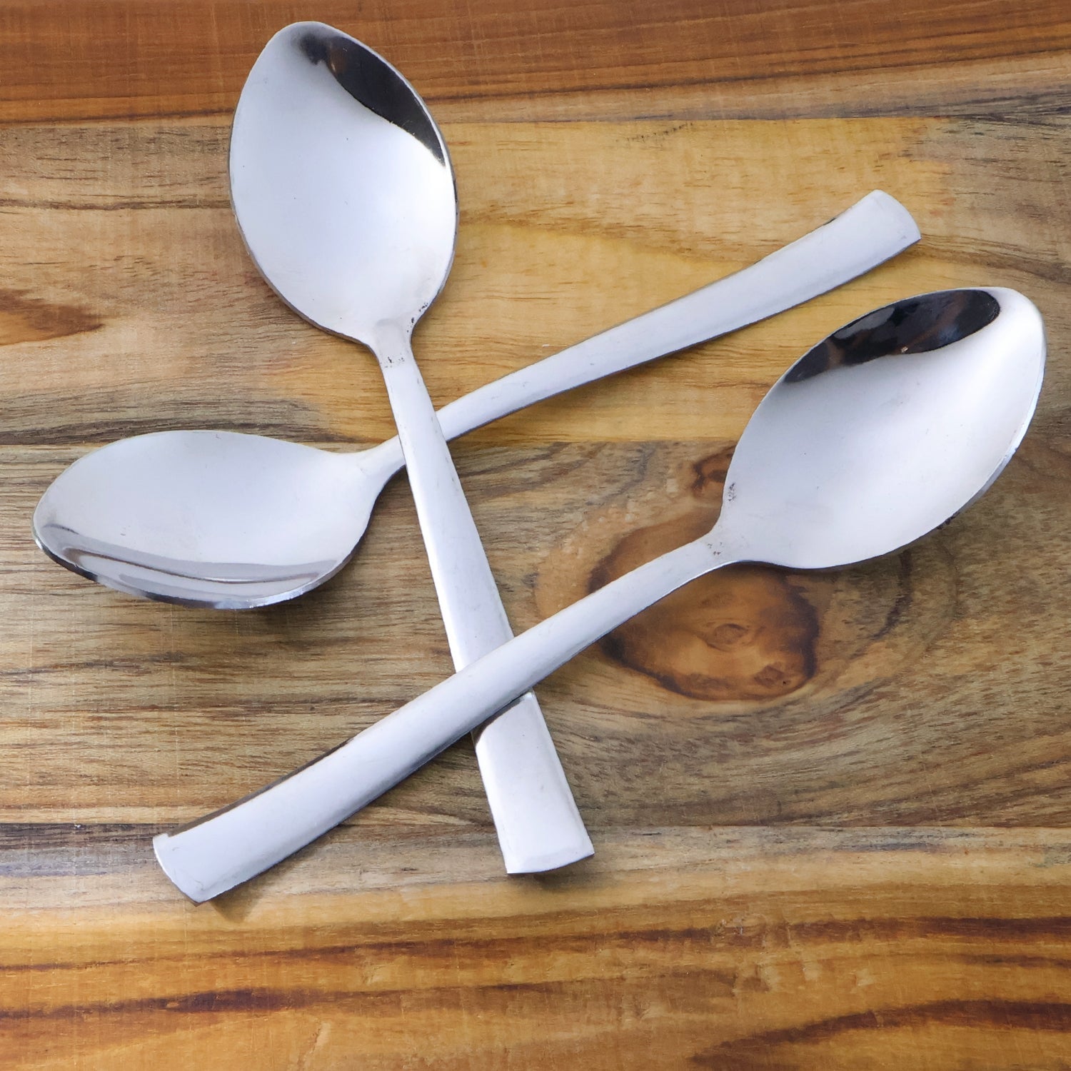 Three rust-resistant dining spoons with smooth oval bowls and comfortable grip handles