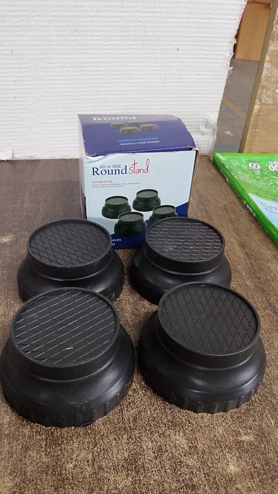Plastic appliance stand elevating a washing machine, preventing rust and easing cleaning.