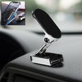 A 360° rotating magnetic car phone holder made of metal, shown on a car dashboard.