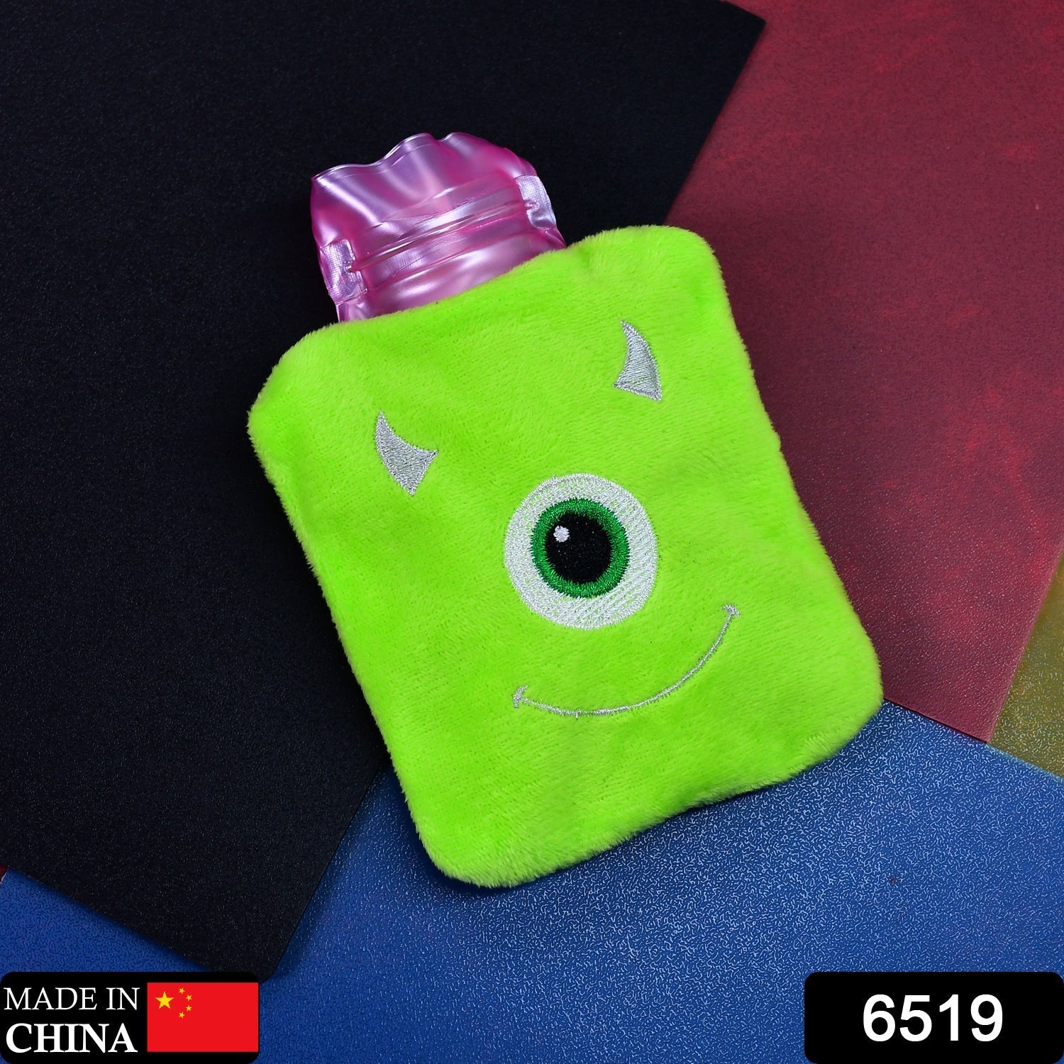 Side view of the monster print hot water bag, showcasing its compact size.