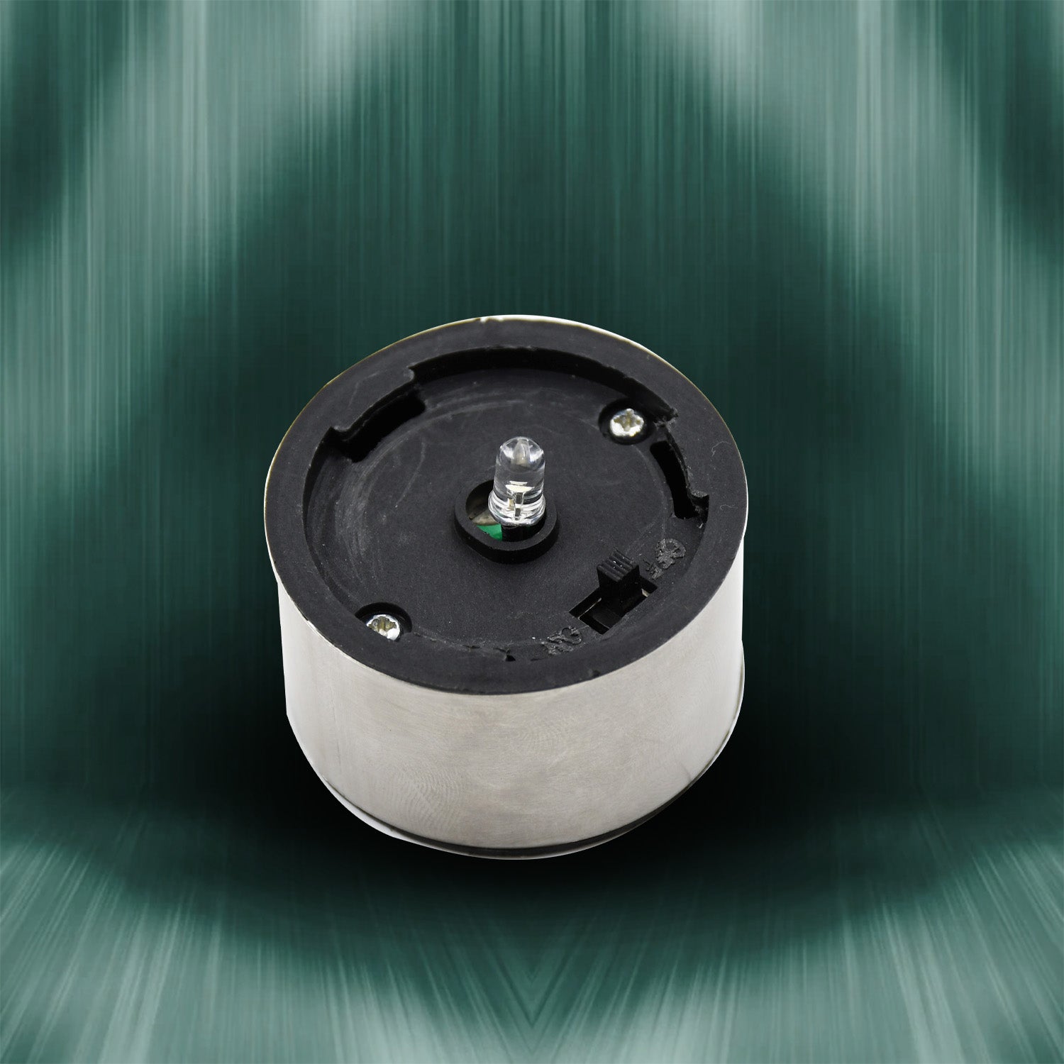 The round silver and black solar cap of the LED light is shown with a clear LED bulb in the center.