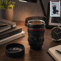 Front view of the camera lens coffee mug with its lid, showcasing realistic design.