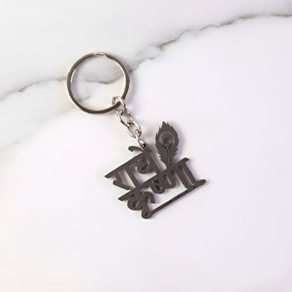 Key pendant attached to Radhe Krishna metal keychain highlighting craftsmanship