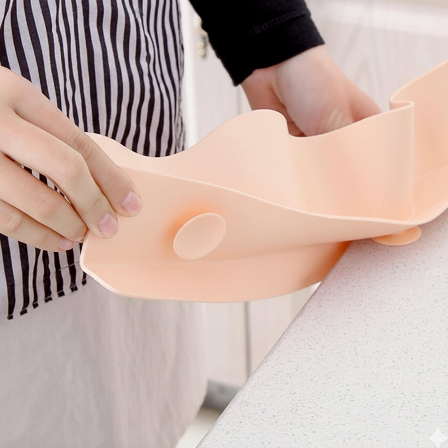 Kitchen splash guard positioned to shield sink area from splashes