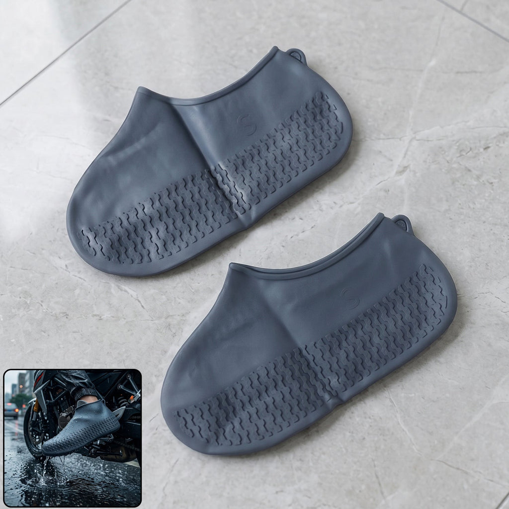 Two gray silicone shoe covers with textured soles lie on a light gray tiled floor, with an inset of a person wearing one on
