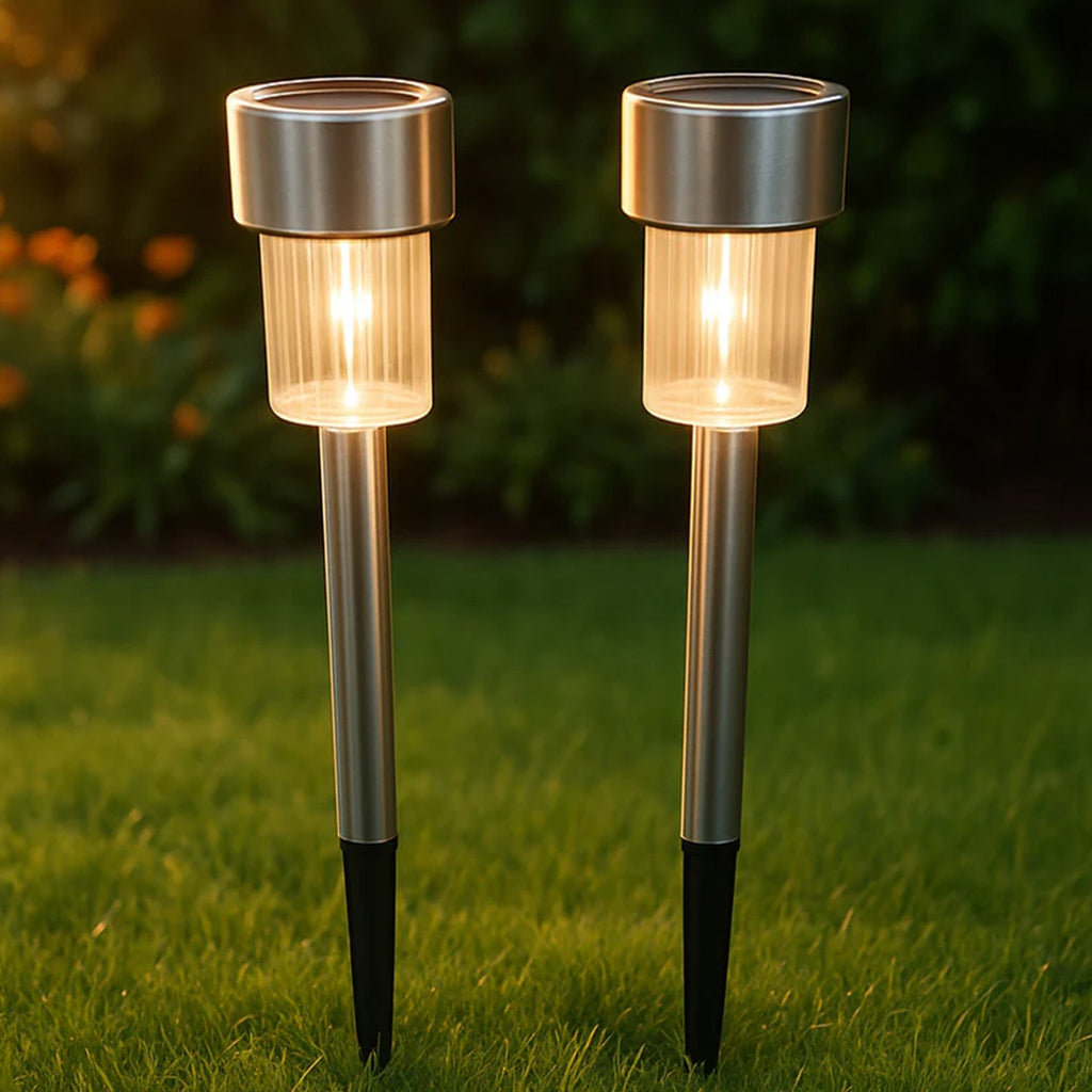 Lifestyle image showing solar lawn lamps illuminating garden edge