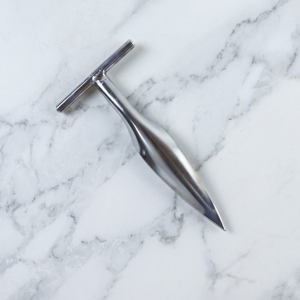 Stainless steel coconut breaker tool set displayed on a white background