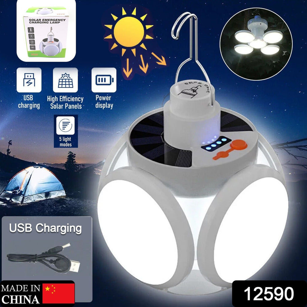 A white Quickslice solar camping light with four bright LED panels illuminates a dark campsite with a tent.
