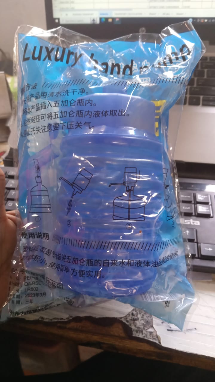 Portable water dispenser being used outdoors, ideal for camping or picnics.