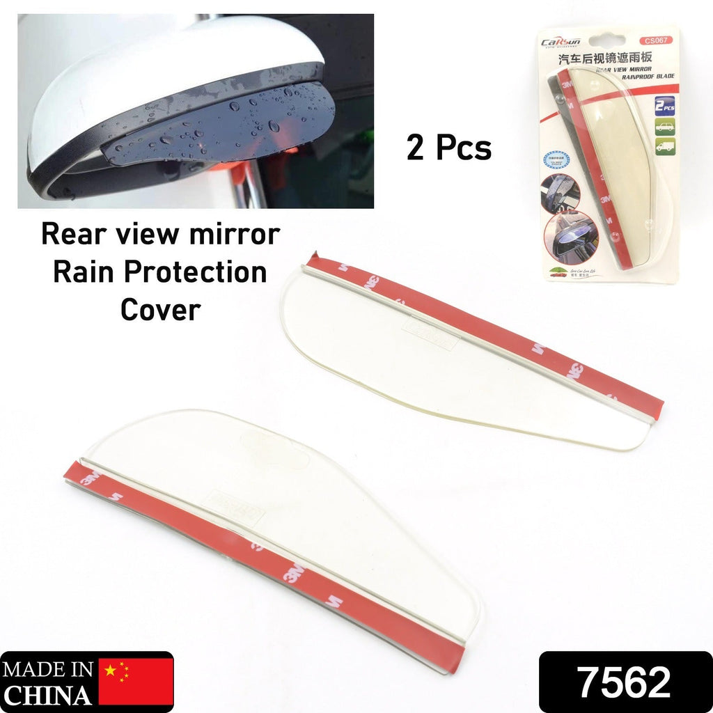 A hand holds a flexible dark grey rain protector, revealing a red adhesive strip on the underside.